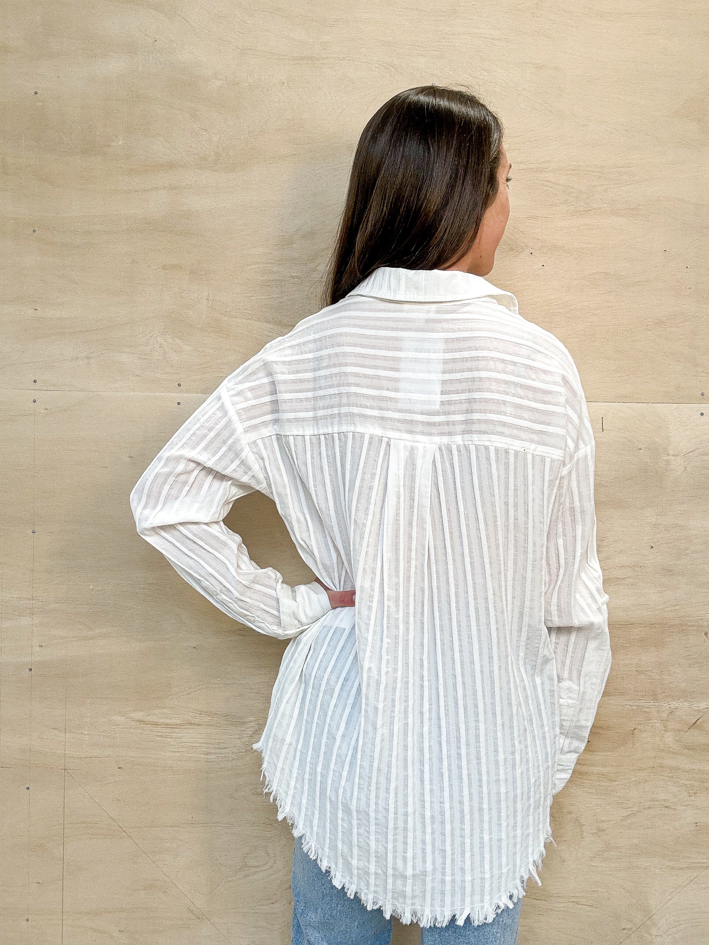 white linen top. stripe design, frayed edges on the bottom, button up, oversized
