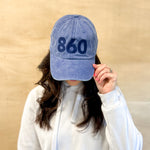Blue baseball cap with blue 860 embroidered on the front, blue anchored american embroidered on the back leather adjustment strap
